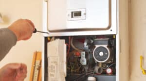 HVAC technician performing furnace repair in a Pasadena home
