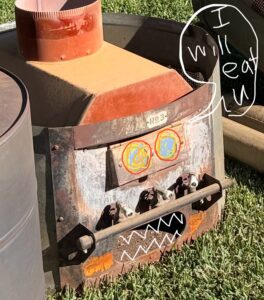 Edited fun photo Humorous edited image of old furnace with scary eyes, teeth, and "I will eat you" speech bubble on grass