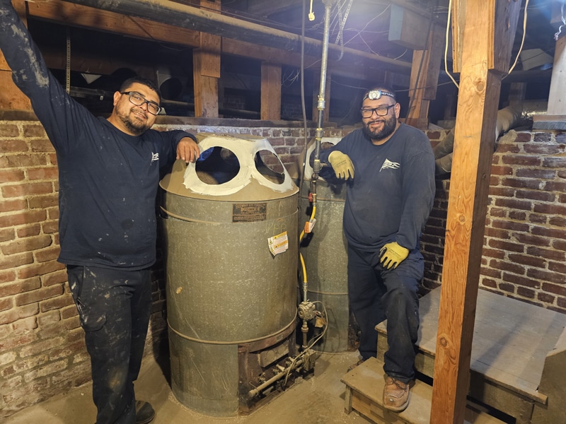 Air-Tro installation team Air-Tro installation technicians posing with old furnace contest winning furnace just before removal and replacement