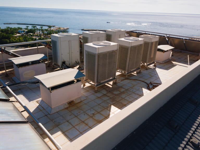 technician performing commercial HVAC maintenance checklist on rooftop unit in Los Angeles