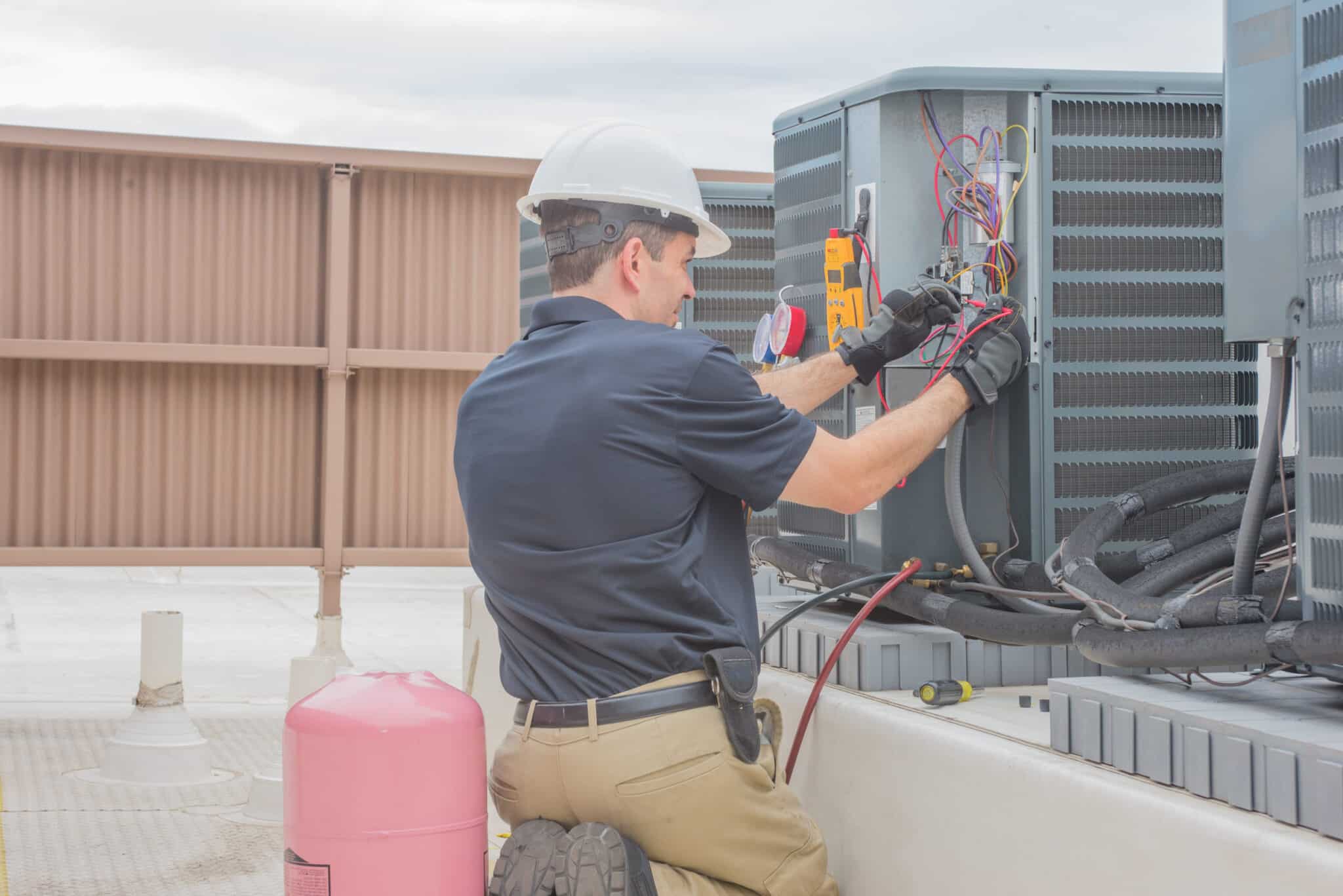 Air-Tro technician performing HVAC maintenance on a Pasadena home air conditioner unit