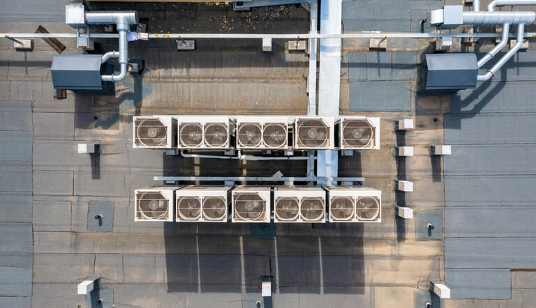 Air-Tro technician performing functional performance testing on commercial HVAC rooftop unit in Los Angeles building
